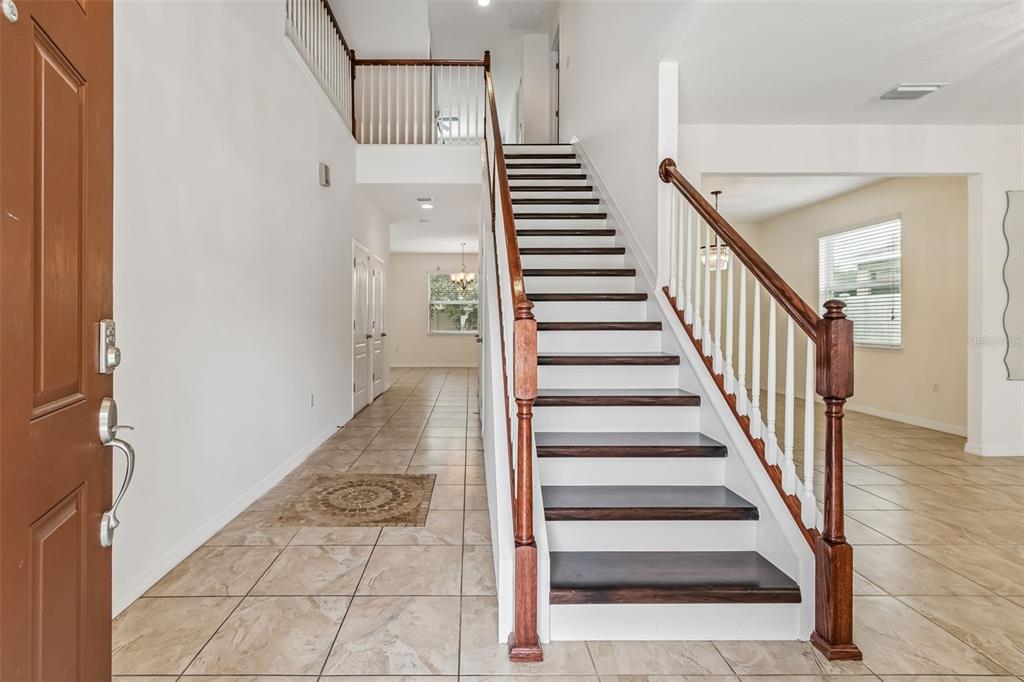 6105 Merrifield Drive Zephyrhills, FL 33541 - Photo 10 of 85 a view of entryway and hall with wooden floor