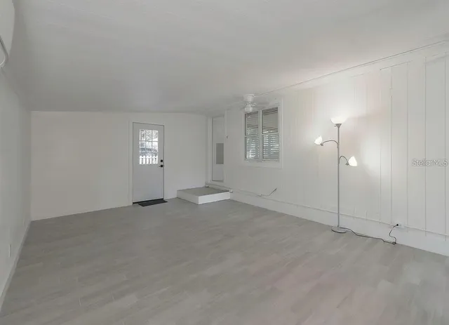 an empty room with windows and closet