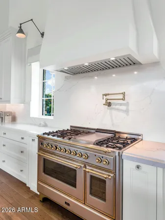 a kitchen with granite countertop a stove and a sink