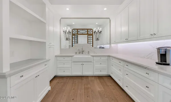 a spacious bathroom with double vanity and a mirror