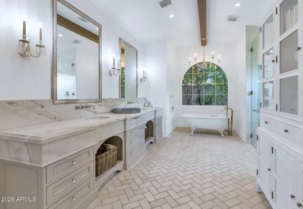 a spacious bathroom with a sink double vanity and a mirror