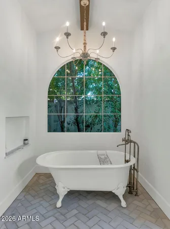 a bathroom with a bathtub and window