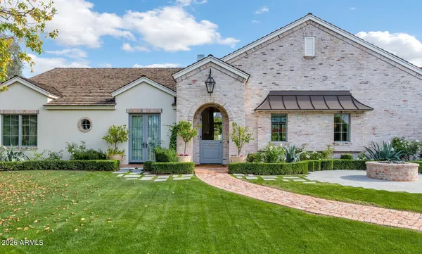 a front view of a house with a garden and plants