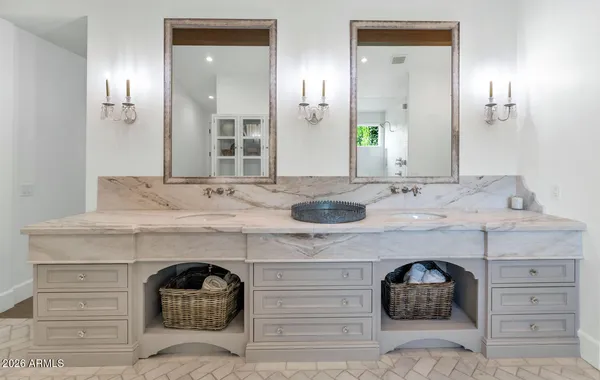 a bathroom with a sink double vanity and a mirror
