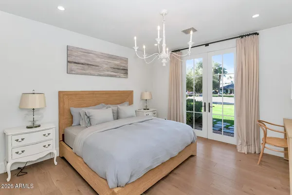 a bedroom with a large bed and a window