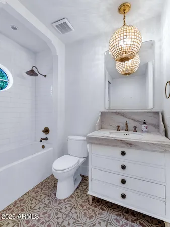 a bathroom with a sink a toilet and a mirror