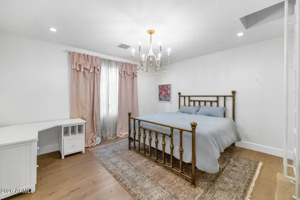 a bedroom with a bed and a chandelier