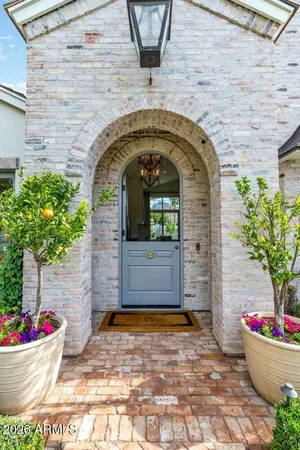 a front view of a house with flower pots