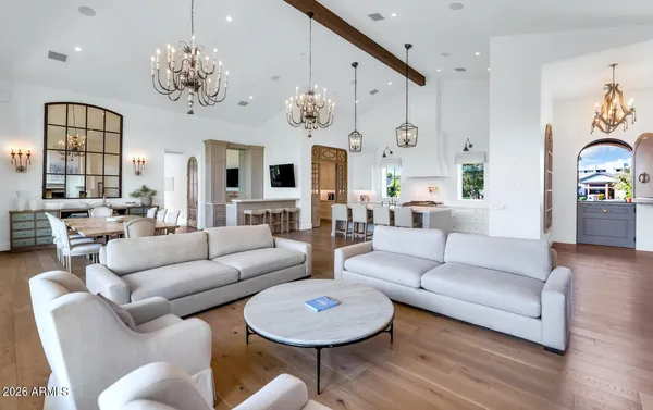 a living room with furniture fireplace and wooden floor
