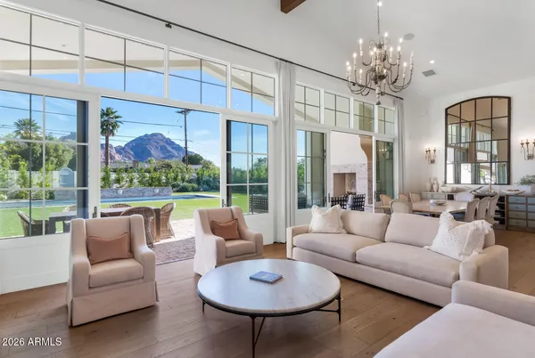 a living room with furniture and a chandelier