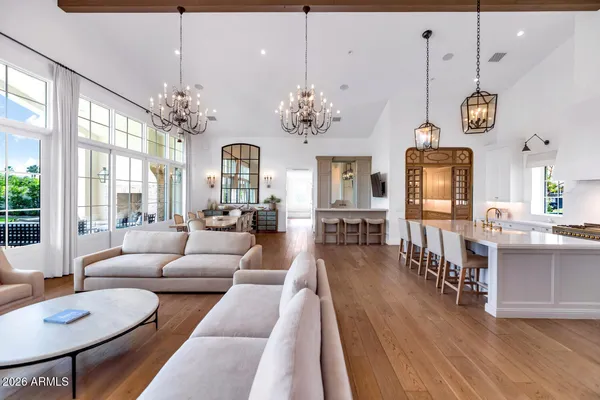 a living room with furniture a chandelier and a dining room