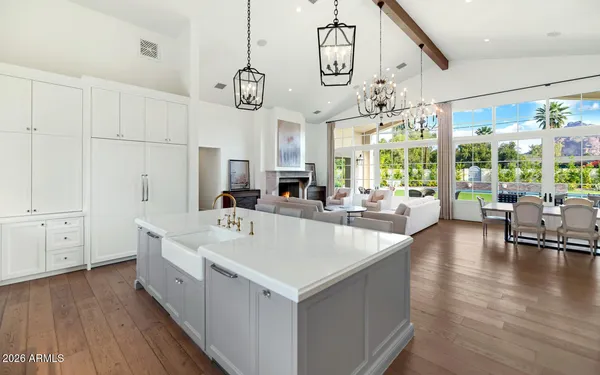 a large white kitchen with a large window