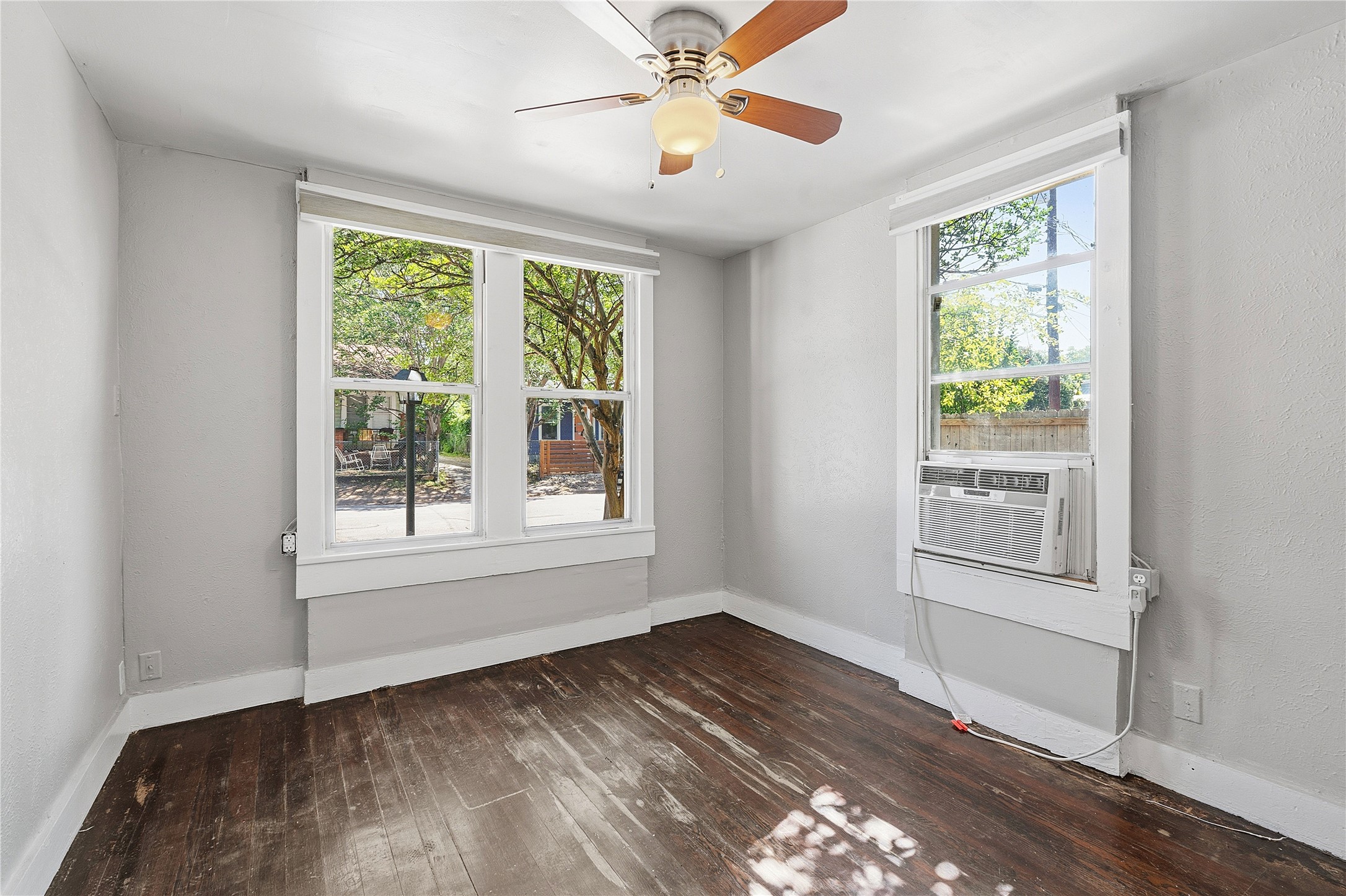 2207 Santa Rita Street Austin, TX 78702 - Photo 8 of 15 Room featuring wood-finish flooring, light grey painted walls, and white trim