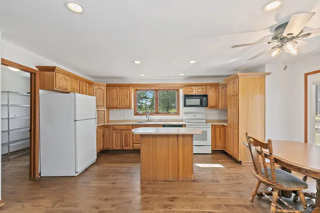 a kitchen with refrigerator cabinets and wooden floor