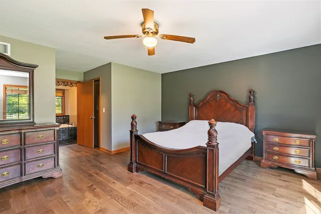 a bedroom with a bed and wooden floor