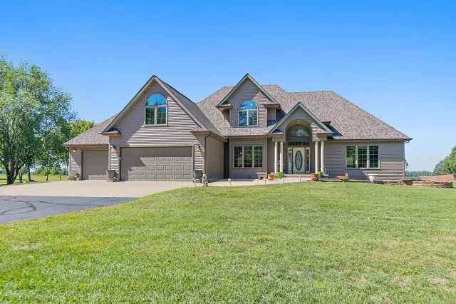 a front view of a house with a garden and porch