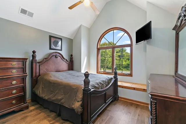 a bedroom with a bed and a window