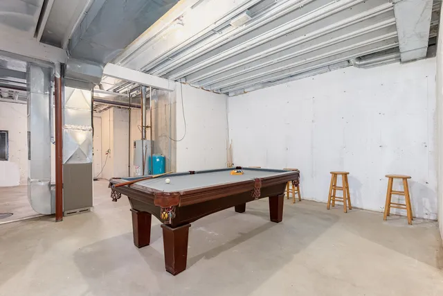a room with pool table and windows