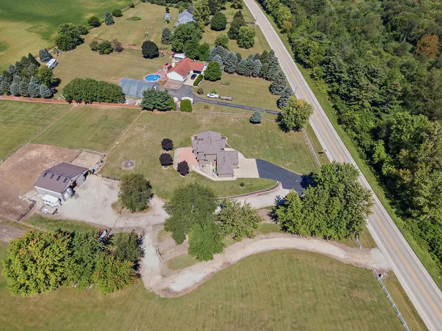 an aerial view of house with yard swimming pool and outdoor seating