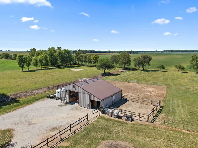 an aerial view of a house with big yard