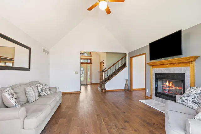 a living room with furniture a fireplace and a flat screen tv