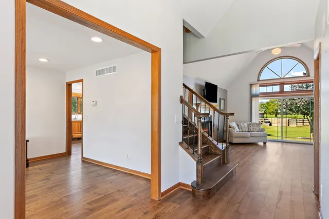 a view of an entryway with wooden floor windows and a livingroom