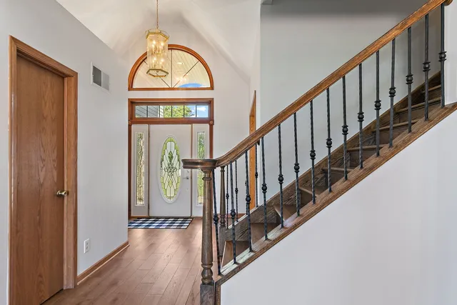 a view of staircase with wooden floor and a window