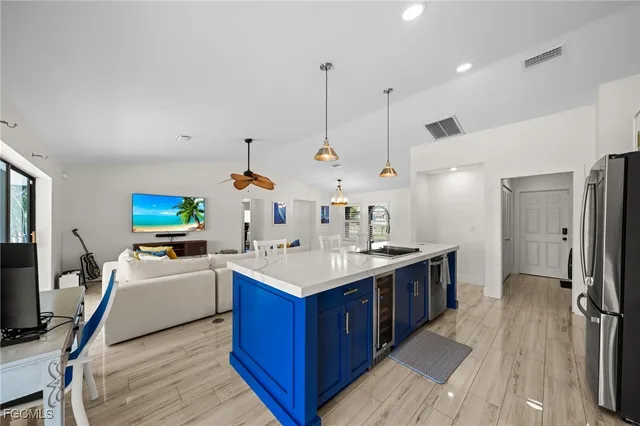 a kitchen with a sink stove and refrigerator