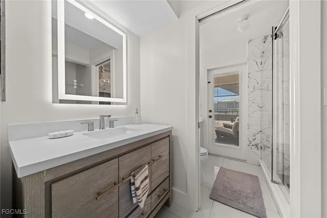 a bathroom with a granite countertop sink mirror and a