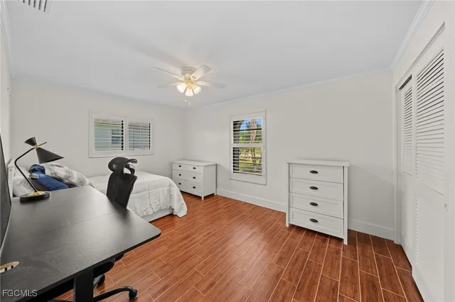 a bedroom with two beds and a dresser with closet