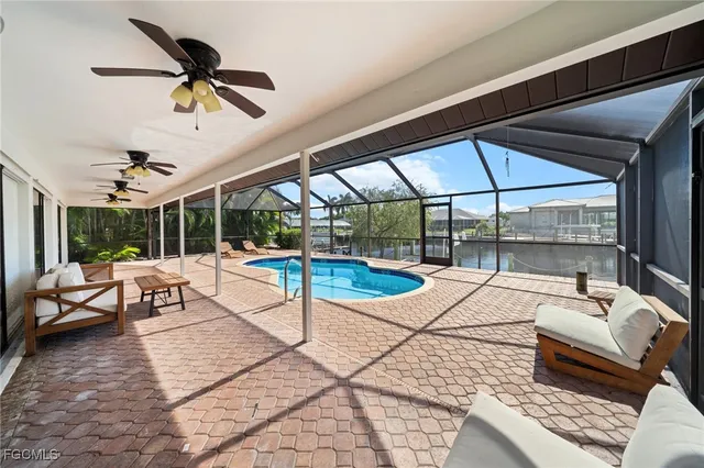 a living room with patio furniture and a large window