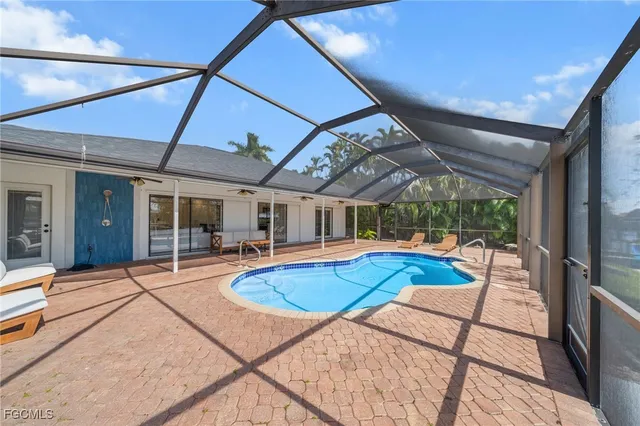 a view of a patio with swimming pool table and chairs