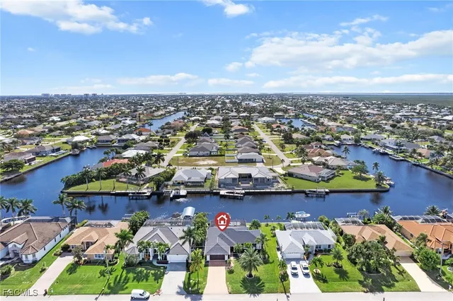 an aerial view of a houses with a lake