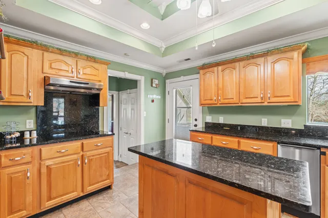 a view of a living room with furniture and a chandelier