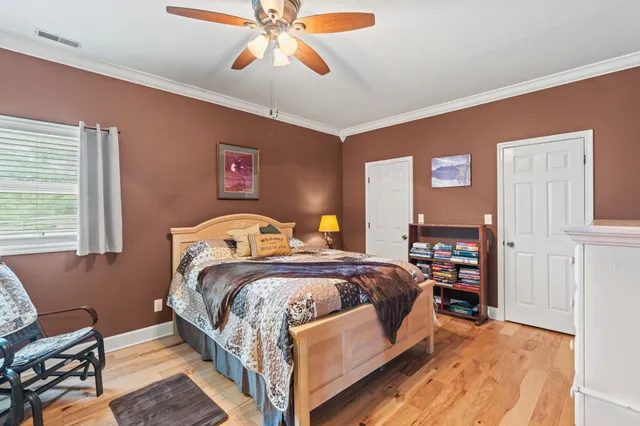 a bedroom with a bed and a chandelier