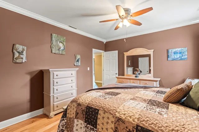 a bedroom with a bed a large window and furniture