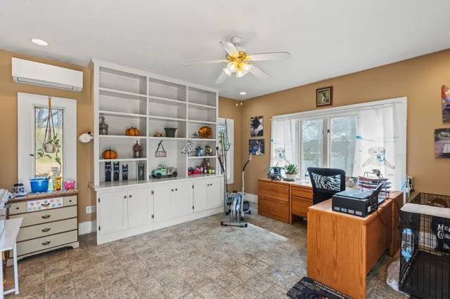 a view of a lake with couches chairs and fire pit