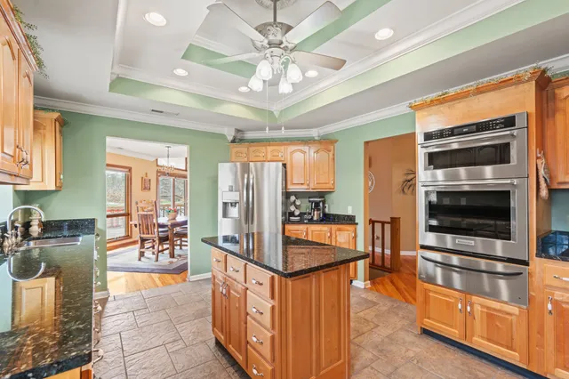 a kitchen with stainless steel appliances granite countertop a sink and cabinets