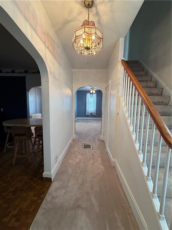 1028 Main Street Republic, PA 15475 - Photo 13 of 27 a view of a hallway with wooden floor and a chandelier