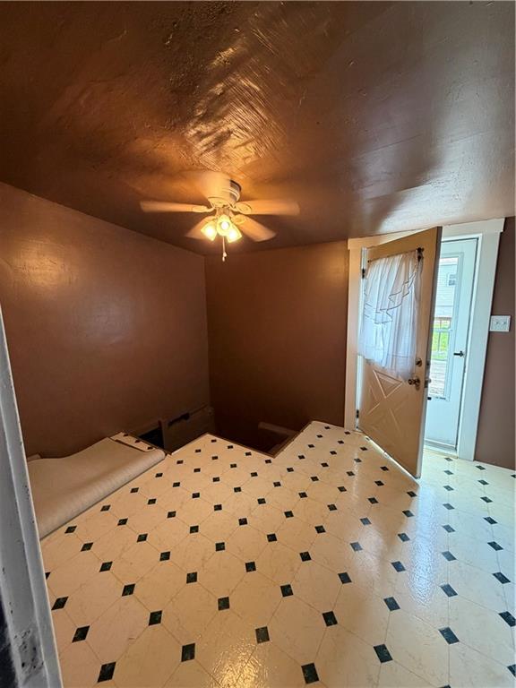 1028 Main Street Republic, PA 15475 - Photo 22 of 27 a bedroom with a bed and a chandelier