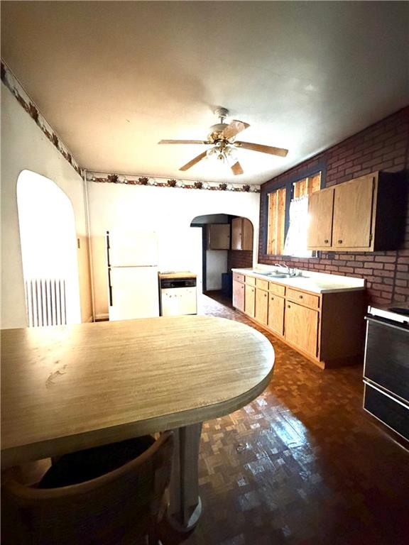 1028 Main Street Republic, PA 15475 - Photo 6 of 27 a kitchen with kitchen island a stove a sink a dining table and chairs