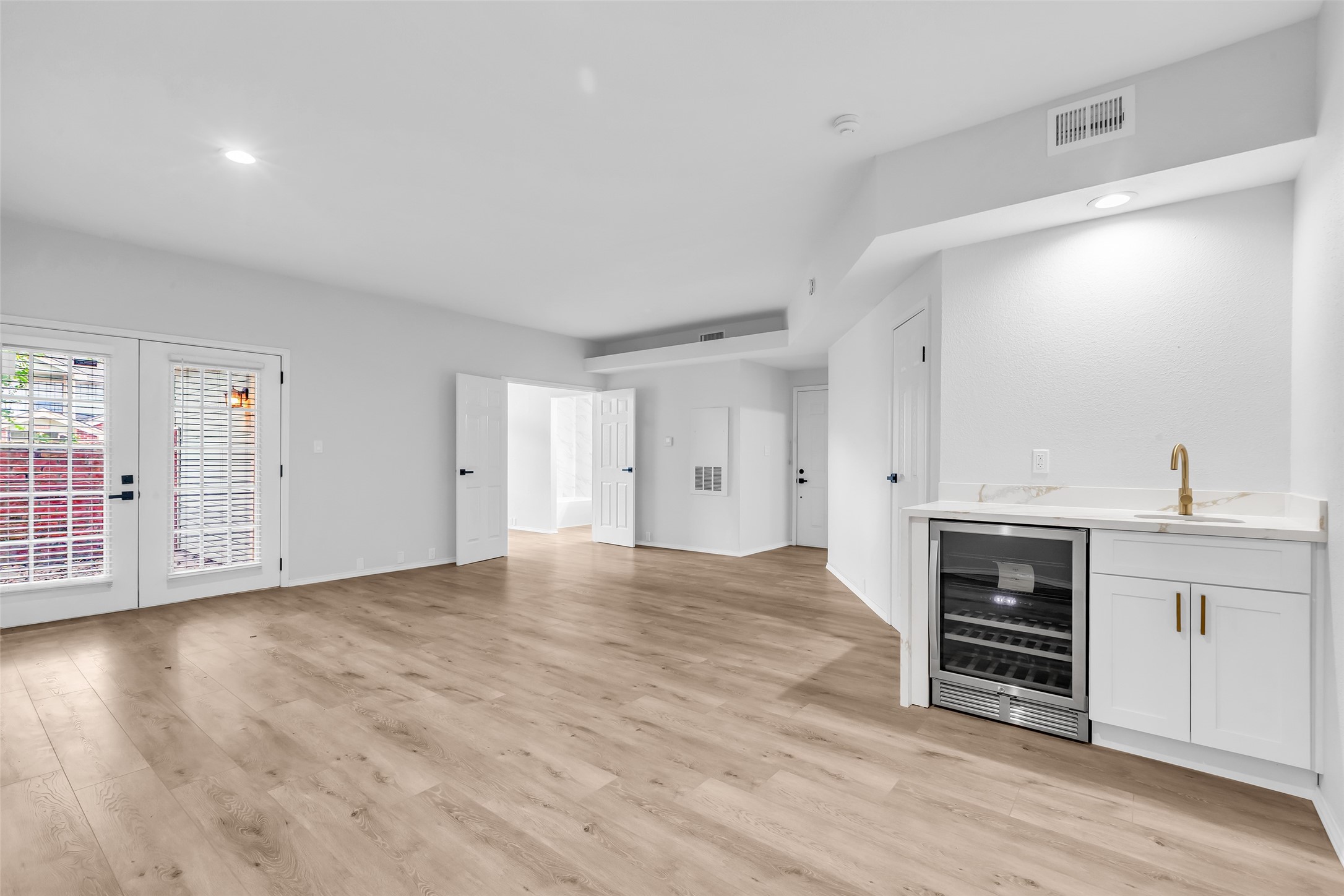 4900 Floyd Street, Unit 10 Houston, TX 77007 - Photo 11 of 30 a view of an empty room with wooden floor and a window