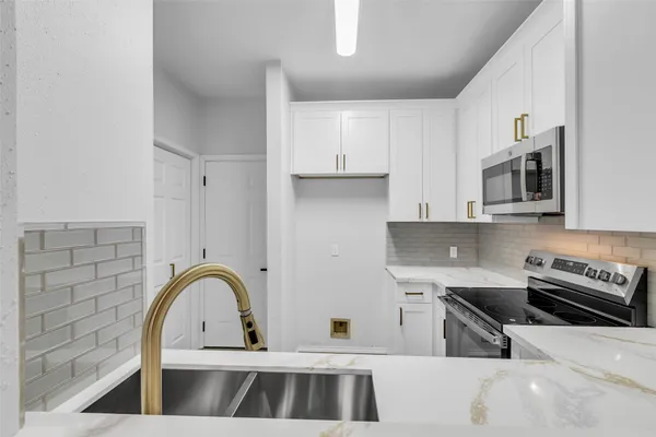 a kitchen with a sink and a stove top oven