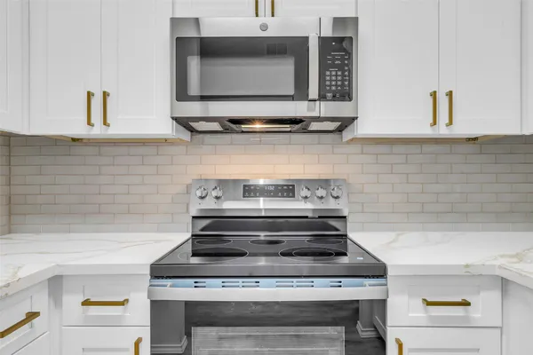 a stove top oven sitting inside of a kitchen