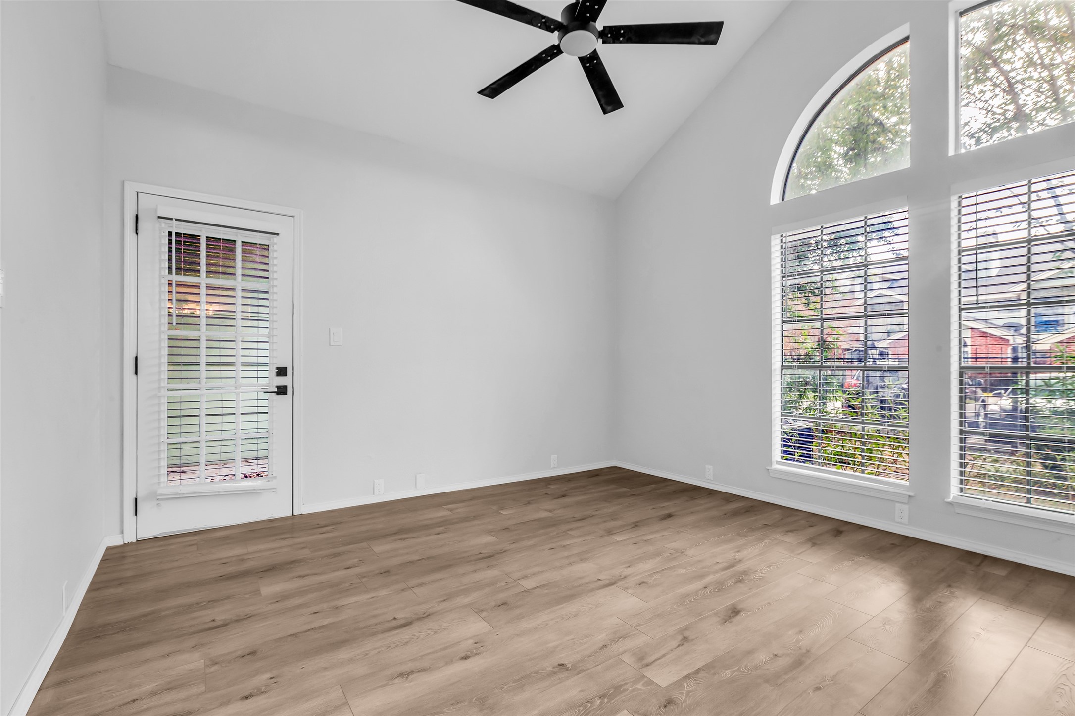4900 Floyd Street, Unit 10 Houston, TX 77007 - Photo 19 of 30 a view of an empty room with a window and wooden floor
