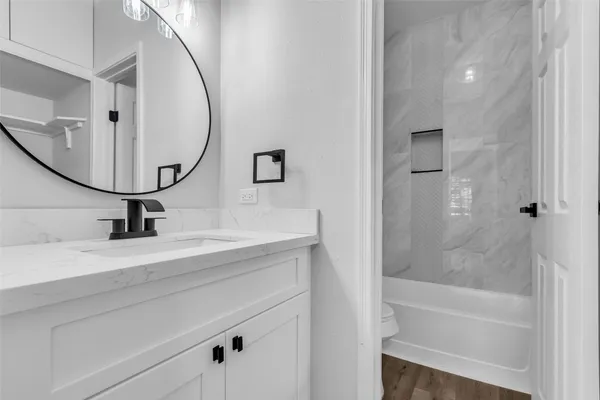 a bathroom with a sink a toilet and a mirror
