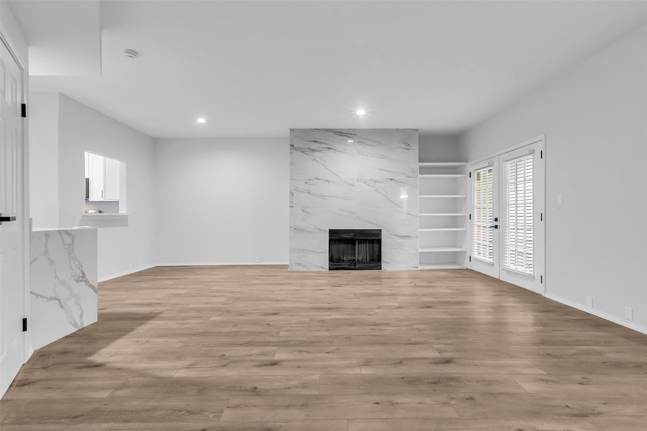 4900 Floyd Street, Unit 10 Houston, TX 77007 - Photo 3 of 30 a view of empty room with wooden floor and fireplace