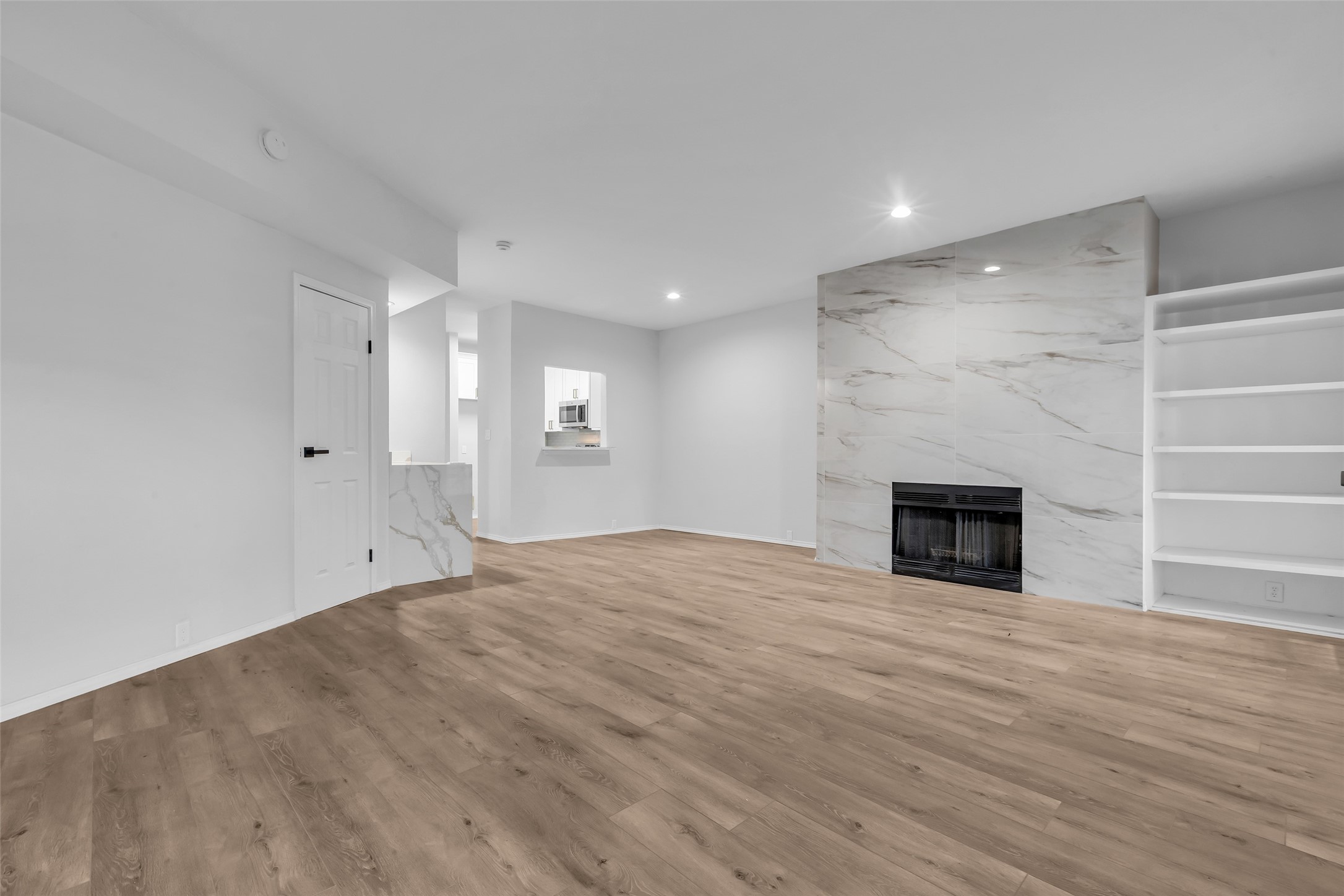 4900 Floyd Street, Unit 10 Houston, TX 77007 - Photo 4 of 30 a view of empty room with wooden floor and fireplace