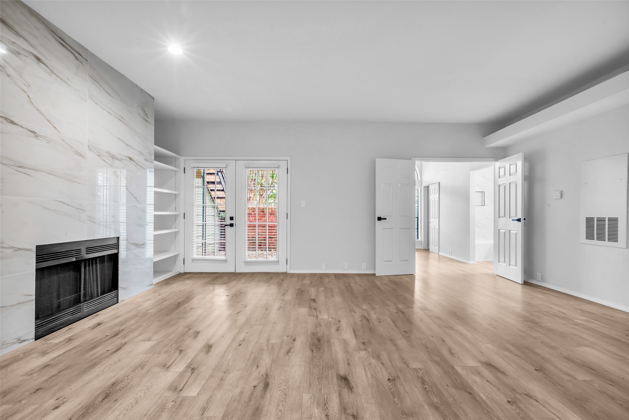 4900 Floyd Street, Unit 10 Houston, TX 77007 - Photo 7 of 30 wooden floor in an empty room with a fireplace