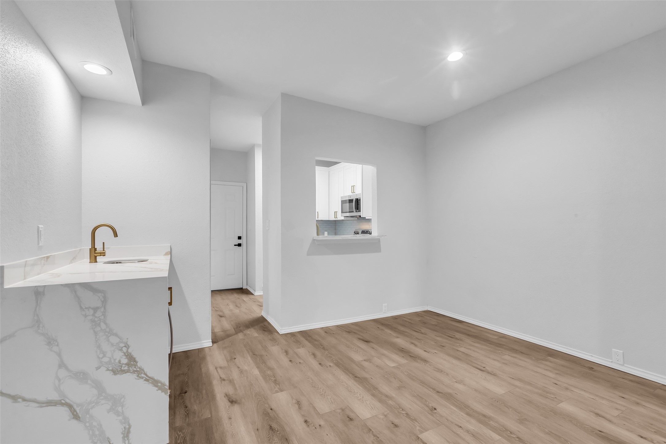 4900 Floyd Street, Unit 10 Houston, TX 77007 - Photo 9 of 30 a view of a kitchen with wooden floor and a sink
